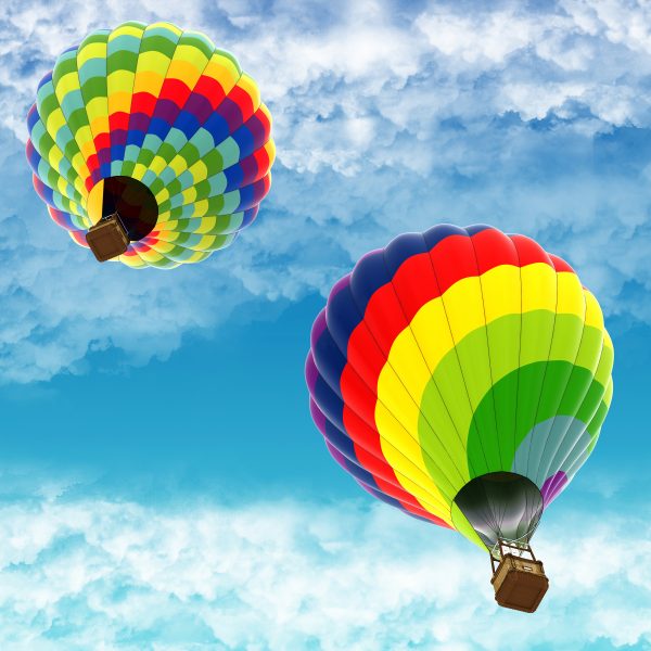 Two hot air balloons on blue sky